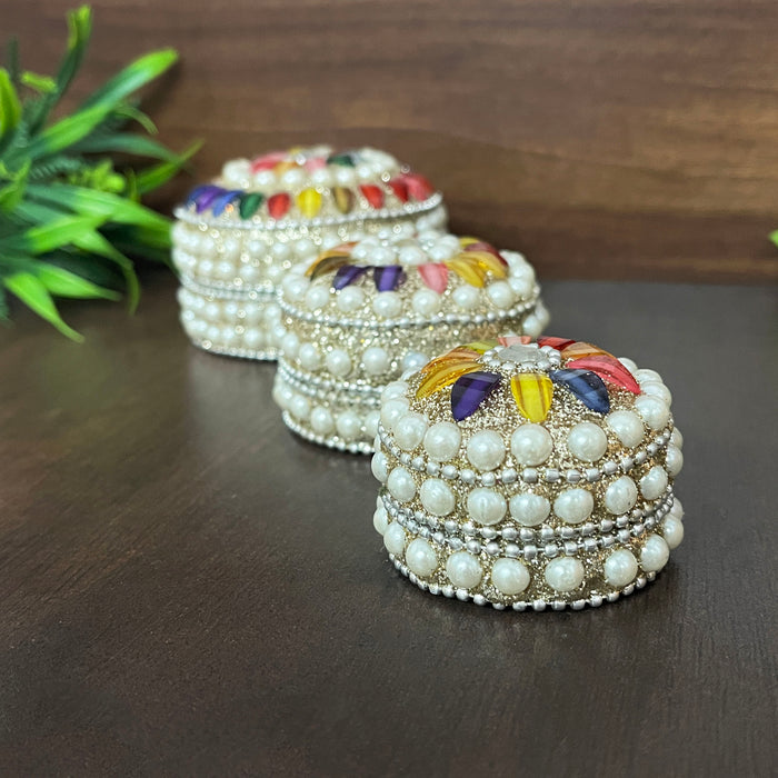 Compact and elegant handcrafted pearl-studded kumkum storage boxes in three sizes.