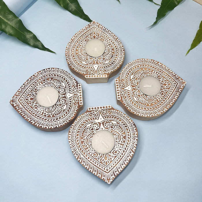 Handcrafted wooden candle holders with intricate leaf design