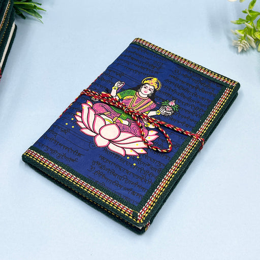 A handmade cotton paper diary with a printed lotus design cover, adorned with goddess Laxmi design in vibrant colors