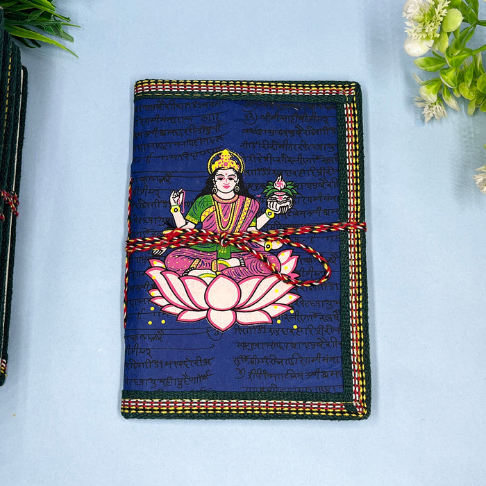 A handmade cotton paper diary with a printed lotus design cover, adorned with goddess Laxmi design in vibrant colors
