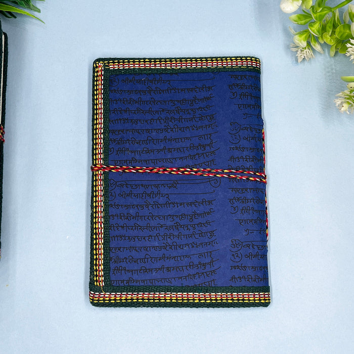A handmade cotton paper diary with a printed lotus design cover, adorned with goddess Laxmi design in vibrant colors