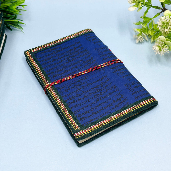 A handmade cotton paper diary with a printed lotus design cover, adorned with goddess Laxmi design in vibrant colors