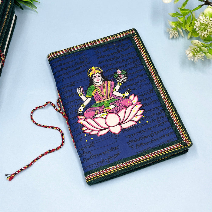 A handmade cotton paper diary with a printed lotus design cover, adorned with goddess Laxmi design in vibrant colors