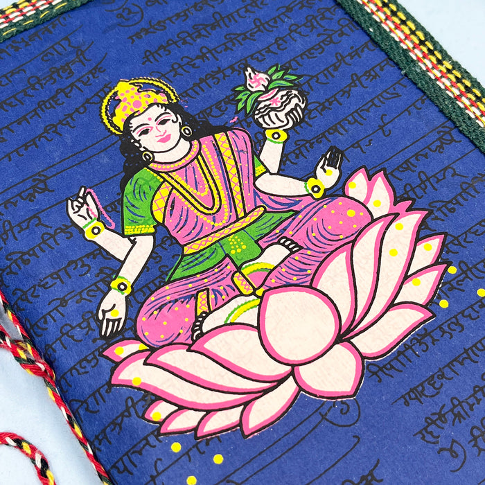 A handmade cotton paper diary with a printed lotus design cover, adorned with goddess Laxmi design in vibrant colors