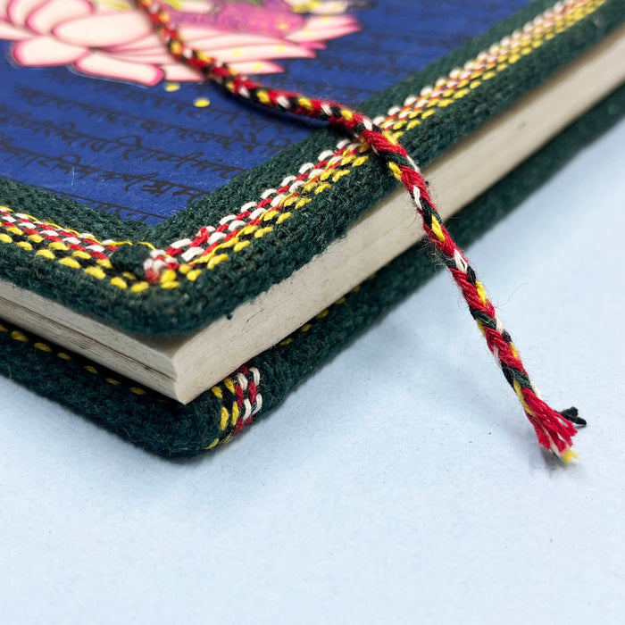 A handmade cotton paper diary with a printed lotus design cover, adorned with goddess Laxmi design in vibrant colors