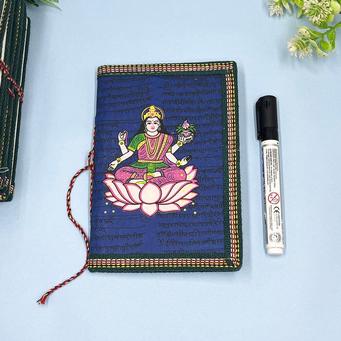 A handmade cotton paper diary with a printed lotus design cover, adorned with goddess Laxmi design in vibrant colors