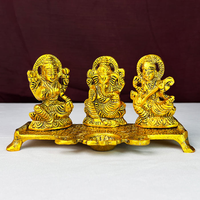 Metal Laxmi Ganesha Saraswati Idols with Diya on Leaf Chowki