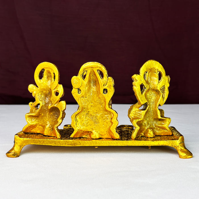 Metal Laxmi Ganesha Saraswati Idols with Diya on Leaf Chowki