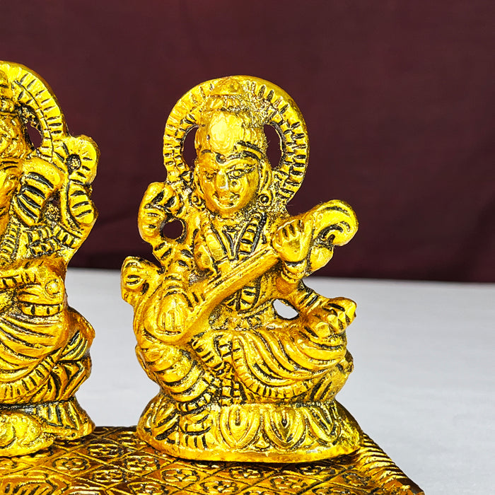 Metal Laxmi Ganesha Saraswati Idols with Diya on Leaf Chowki